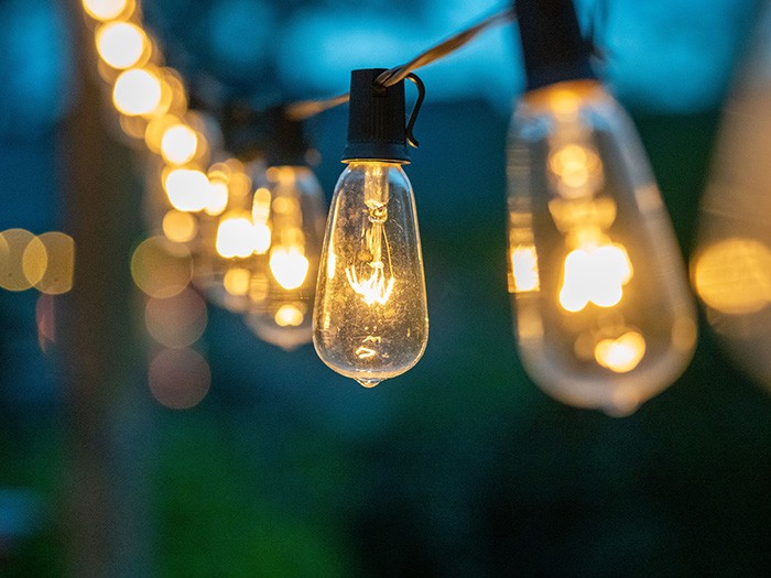 Vintage patio string lights  with blurred background and focus on dim lights